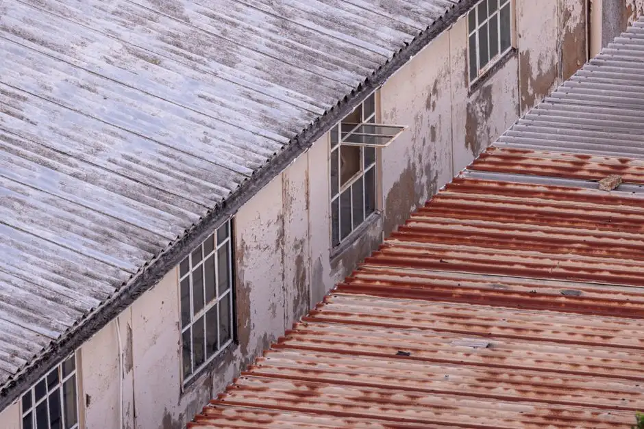 Aerial view of a rustic industrial building with corrugated metal roofing and weathered walls.